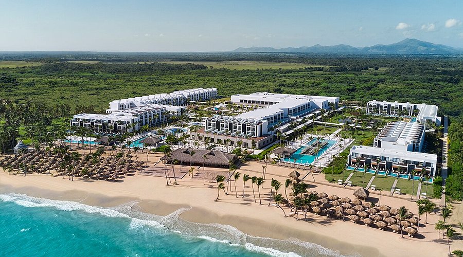 Excellence Punta Cana adults-only all-inclusive resort with beachfront suites and tropical pool landscapes.