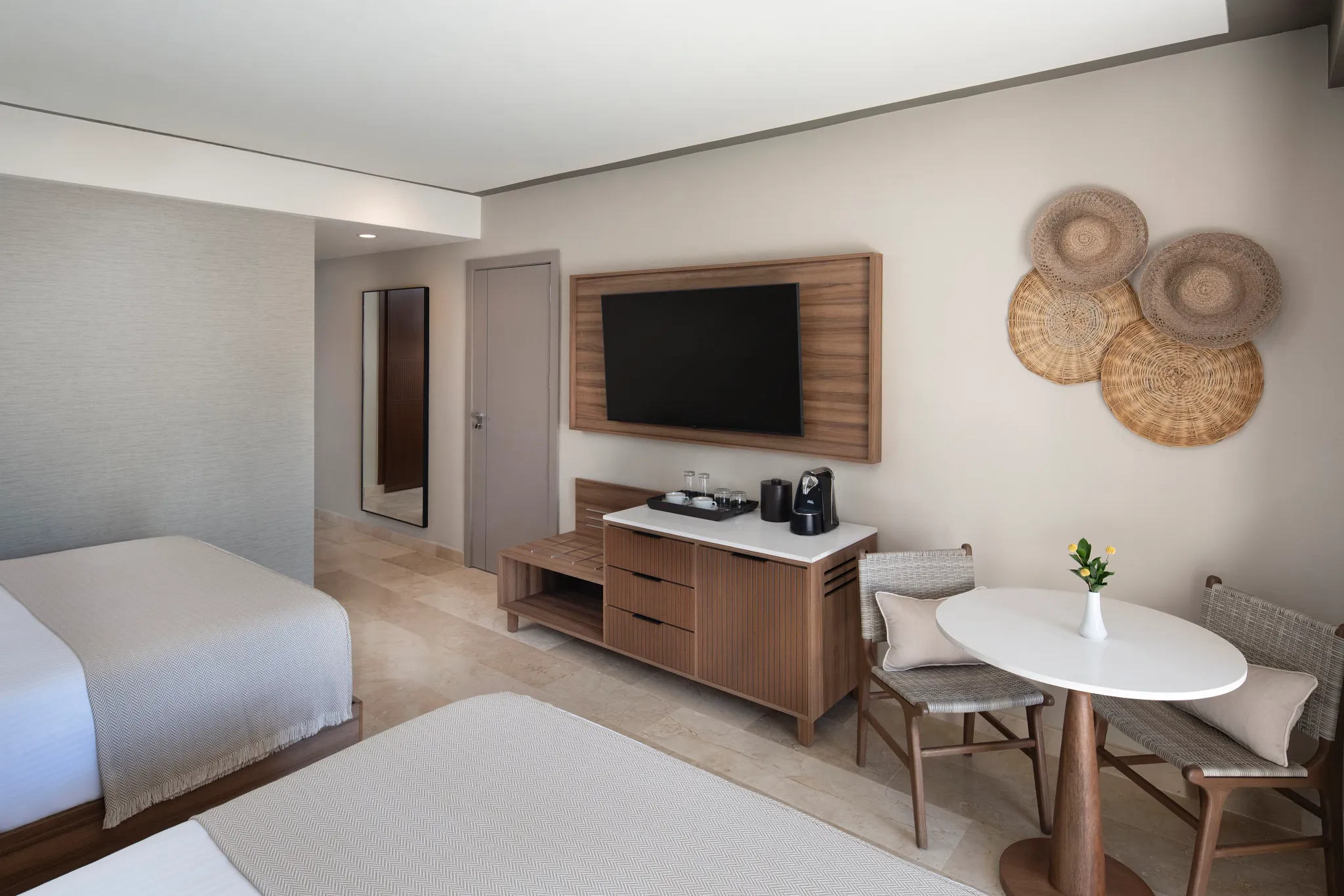 Modern hotel room interior with two queen beds, seating area, and sleek amenities at Hyatt Vivid Punta Cana.