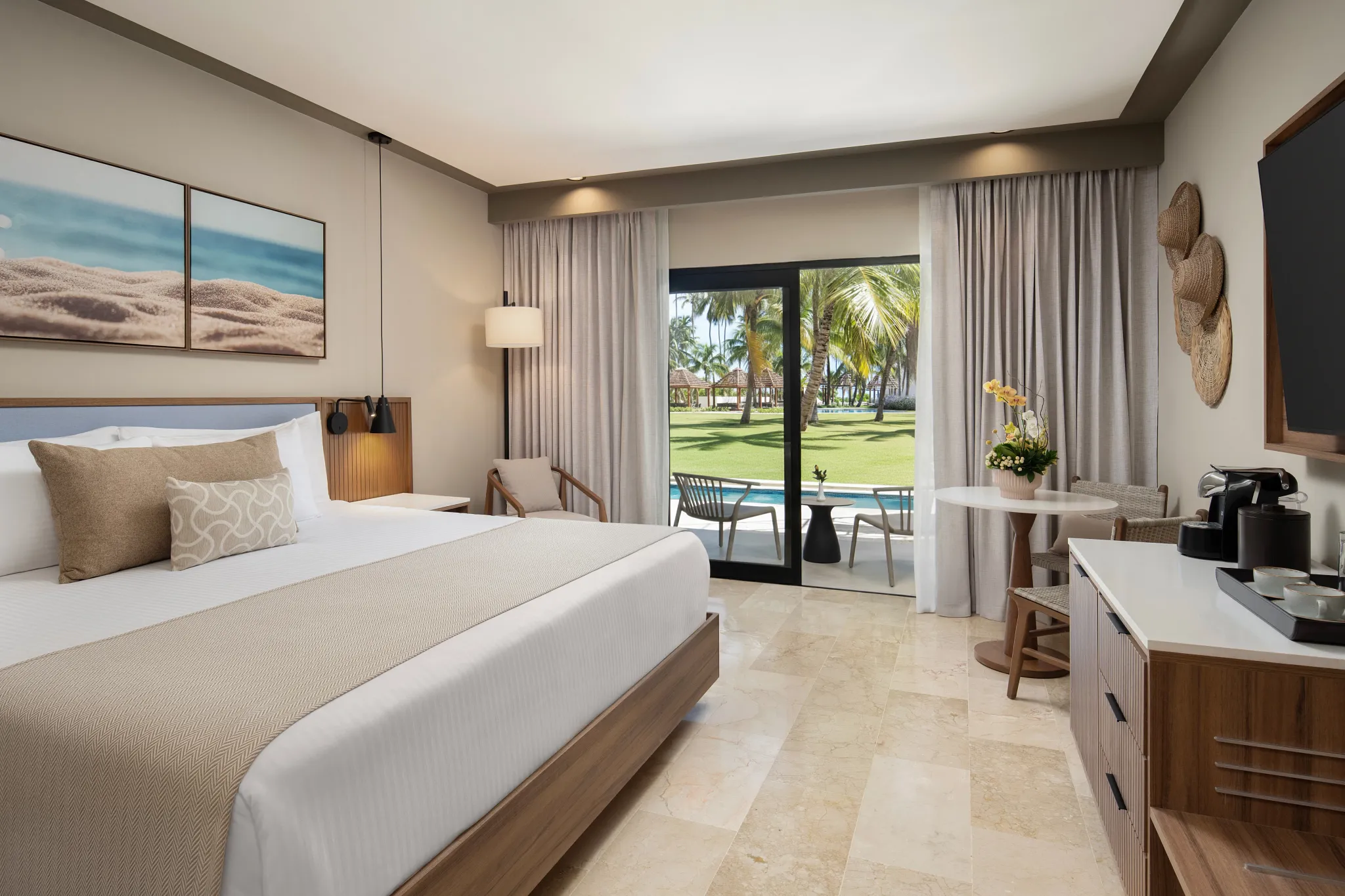 King bed guest room with private terrace overlooking tropical gardens at Hyatt Vivid Punta Cana.