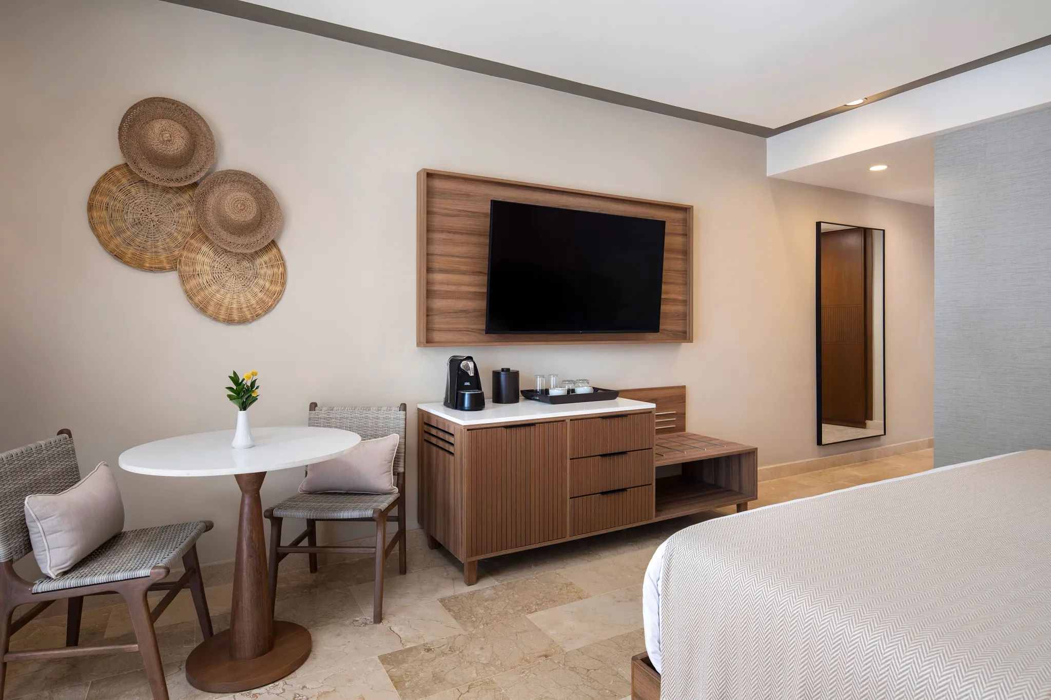 Stylish hotel room with king bed, seating area, and modern amenities at Hyatt Vivid Punta Cana.